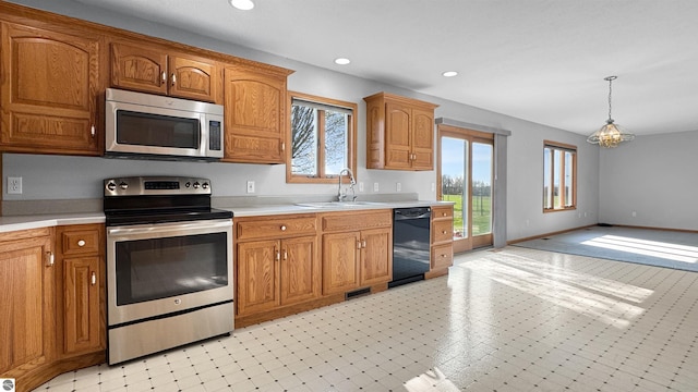 20202 50th Ave, Marion, MI 49665 - kitchen with stainless steel appliances, a sink, light countertops, brown cabinets, and recessed lighting