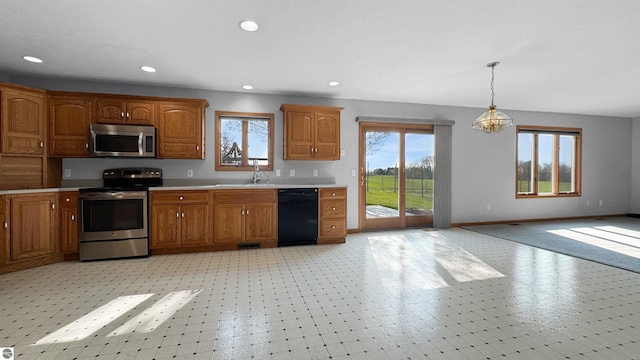 20202 50th Ave, Marion, MI 49665 - kitchen with appliances with stainless steel finishes, a sink, light countertops, brown cabinets, and recessed lighting