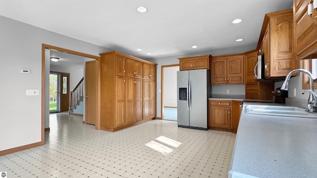 20202 50th Ave, Marion, MI 49665 - kitchen featuring stainless steel refrigerator with ice dispenser, baseboards, recessed lighting, brown cabinets, and a sink