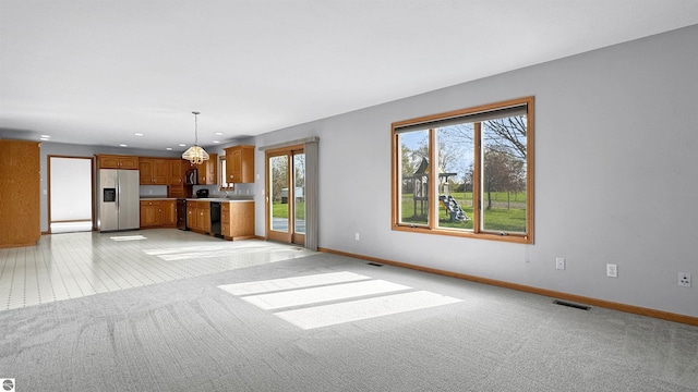 20202 50th Ave, Marion, MI 49665 - unfurnished living room with healthy amount of natural light, light carpet, baseboards, and recessed lighting