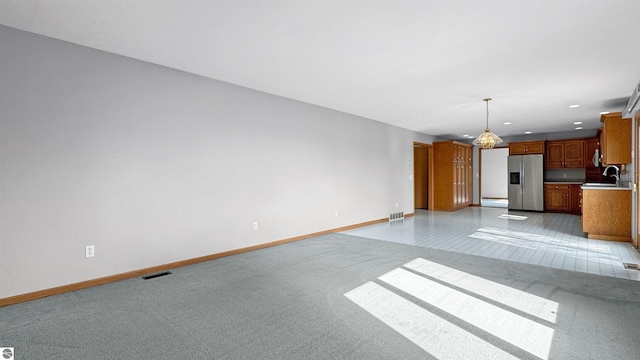 20202 50th Ave, Marion, MI 49665 - unfurnished living room with baseboards, light colored carpet, recessed lighting, and a sink