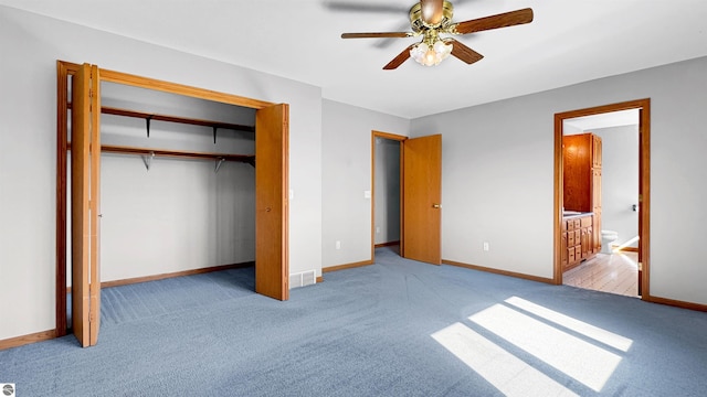 20202 50th Ave, Marion, MI 49665 - unfurnished bedroom featuring carpet, a closet, baseboards, ensuite bath, and a ceiling fan