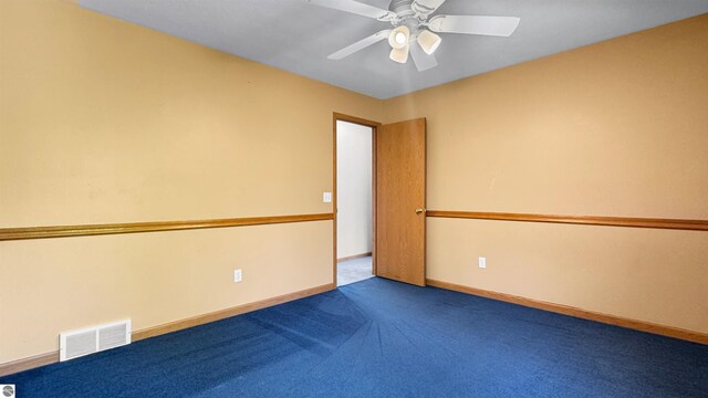 20202 50th Ave, Marion, MI 49665 - spare room featuring a ceiling fan, carpet floors, and baseboards