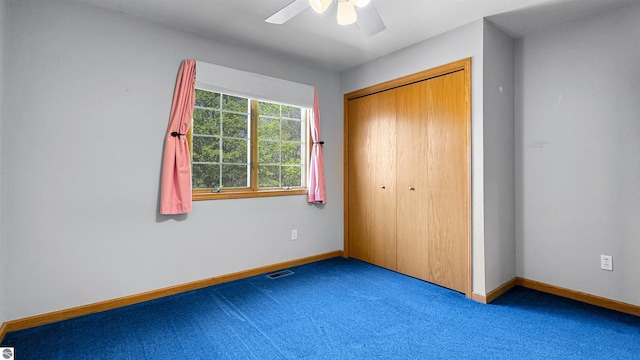 20202 50th Ave, Marion, MI 49665 - unfurnished bedroom featuring carpet flooring, baseboards, a closet, and a ceiling fan