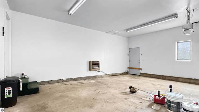 20202 50th Ave, Marion, MI 49665 - garage with a garage door opener and heating unit