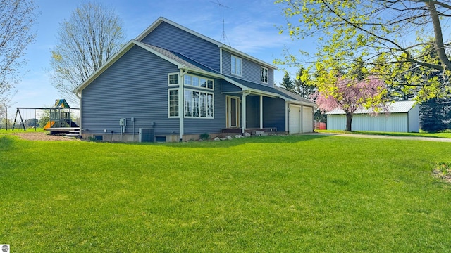 20202 50th Ave, Marion, MI 49665 - rear view of house with a lawn, an attached garage, and driveway