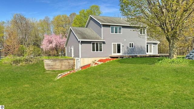 20202 50th Ave, Marion, MI 49665 - back of property with a wooden deck, a lawn, and roof with shingles