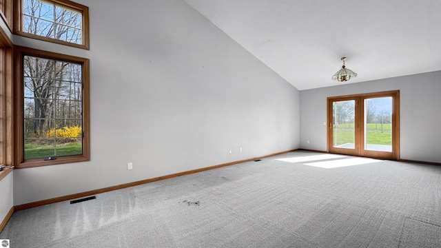 20202 50th Ave, Marion, MI 49665 - spare room featuring baseboards, healthy amount of natural light, carpet floors, and high vaulted ceiling
