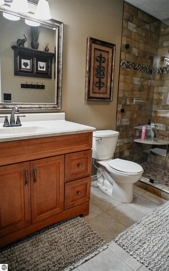 11255 E Fort Rd Unit H1, Suttons Bay, MI 49682 - bathroom featuring tiled shower, toilet, vanity, and tile patterned flooring