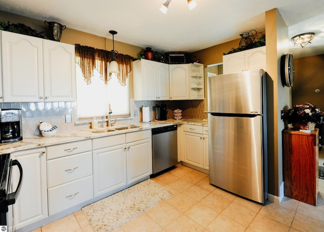 11255 E Fort Rd Unit H1, Suttons Bay, MI 49682 - kitchen with stainless steel appliances, a sink, backsplash, white cabinets, and light stone counters