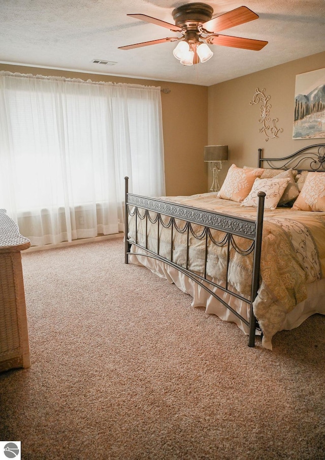 11255 E Fort Rd Unit H1, Suttons Bay, MI 49682 - bedroom with carpet, ceiling fan, and a textured ceiling