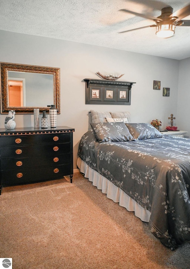 11255 E Fort Rd Unit H1, Suttons Bay, MI 49682 - bedroom with carpet floors, a ceiling fan, and a textured ceiling
