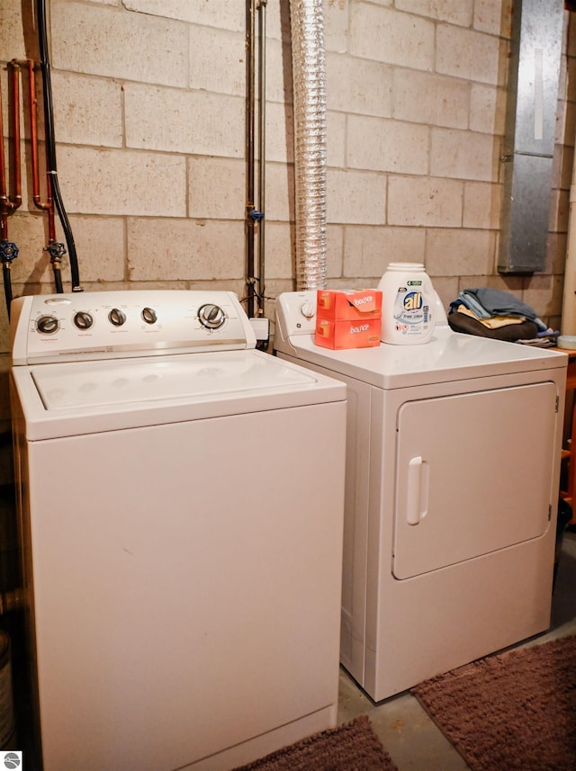 11255 E Fort Rd Unit H1, Suttons Bay, MI 49682 - clothes washing area with washer and clothes dryer and concrete block wall