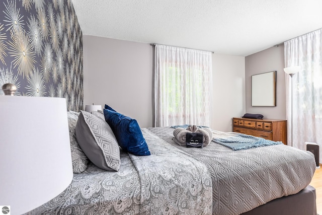 5540 Golf Meadows Dr, Bellaire, MI 49615 - bedroom featuring a textured ceiling