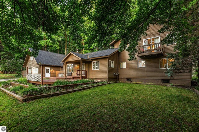 5540 Golf Meadows Dr, Bellaire, MI 49615 - rear view of property featuring a yard and a balcony