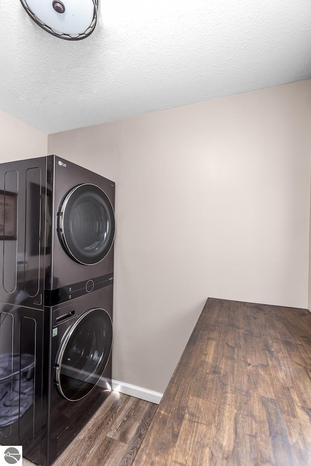 5540 Golf Meadows Dr, Bellaire, MI 49615 - washroom with stacked washer / drying machine, wood finished floors, and a textured ceiling