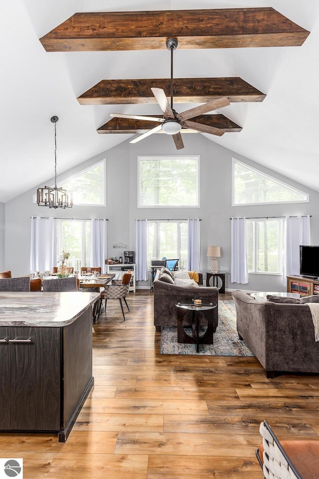 5540 Golf Meadows Dr, Bellaire, MI 49615 - living area featuring high vaulted ceiling, ceiling fan, beam ceiling, plenty of natural light, and light wood-type flooring