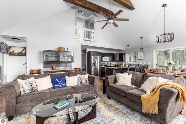 5540 Golf Meadows Dr, Bellaire, MI 49615 - living area featuring high vaulted ceiling, wood finished floors, a chandelier, a ceiling fan, and beam ceiling