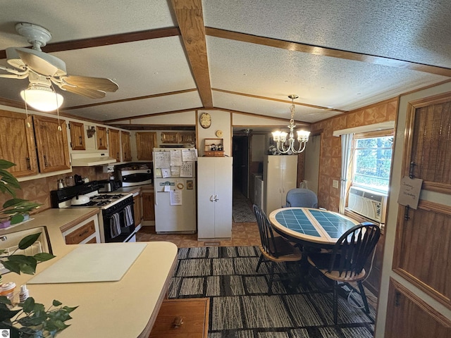 4505 Goldenrod Dr, Traverse City, MI 49685 - kitchen featuring freestanding refrigerator, gas range, under cabinet range hood, stainless steel microwave, and vaulted ceiling
