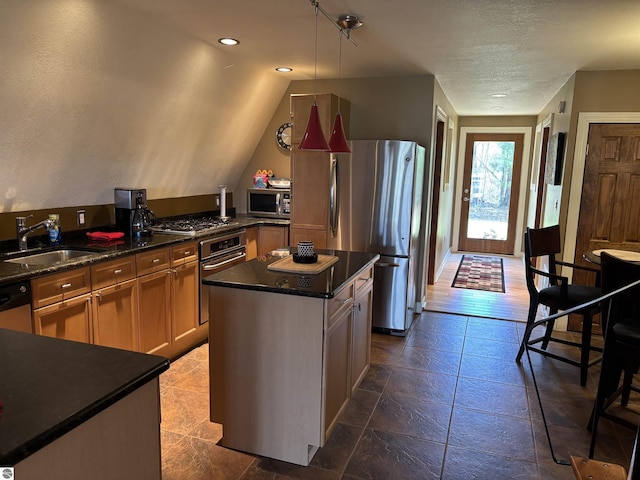 2050 Hiawatha Dr, Cadillac, MI 49601 - kitchen featuring a sink, stainless steel appliances, a center island, decorative light fixtures, and a textured ceiling