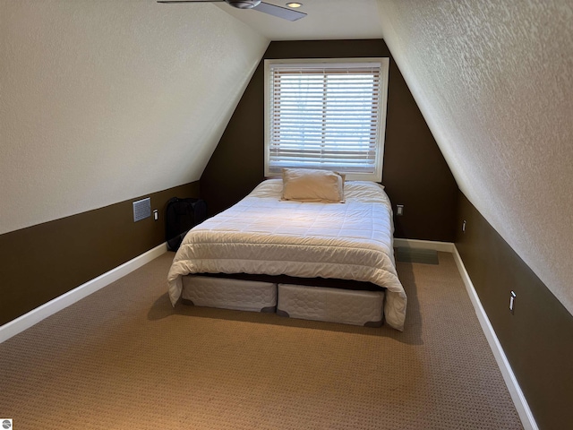 2050 Hiawatha Dr, Cadillac, MI 49601 - carpeted bedroom with lofted ceiling and baseboards