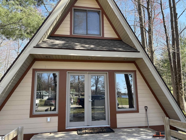 2050 Hiawatha Dr, Cadillac, MI 49601 - view of property exterior featuring a shingled roof and french doors