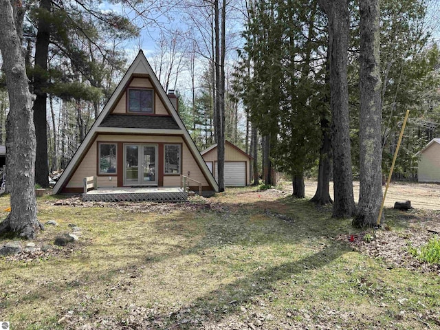 2050 Hiawatha Dr, Cadillac, MI 49601 - rear view of property with french doors, a chimney, an outbuilding, and a detached garage