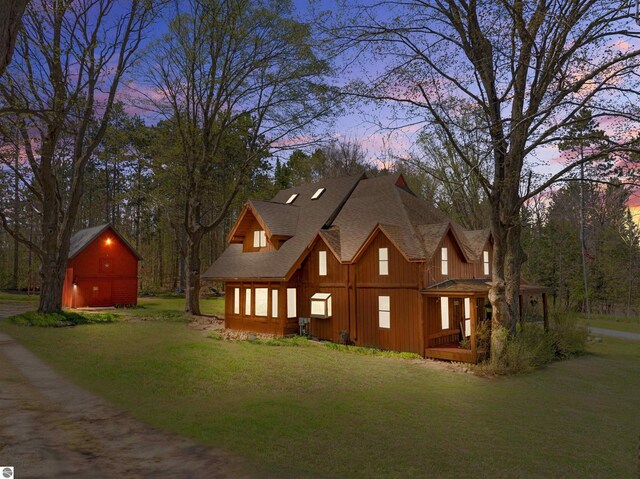 512 Indiana St, Manton, MI 49663 - view of front facade with a lawn, a shingled roof, and board and batten siding