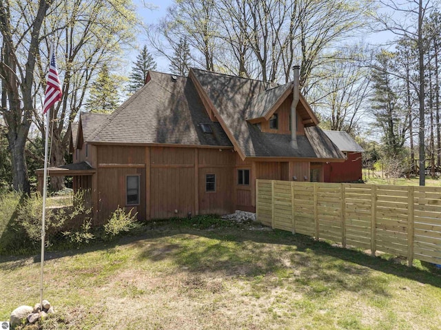 512 Indiana St, Manton, MI 49663 - rear view of house featuring roof with shingles