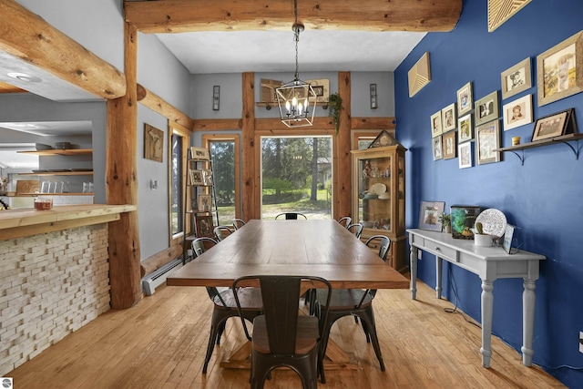 512 Indiana St, Manton, MI 49663 - dining area with baseboard heating, light wood-style floors, a chandelier, and beamed ceiling