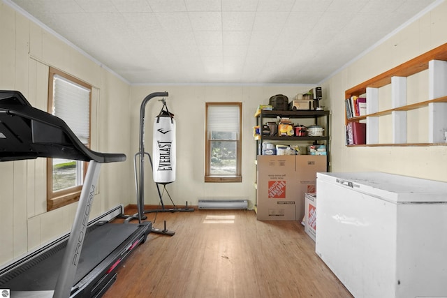 512 Indiana St, Manton, MI 49663 - workout area featuring crown molding, light wood-style flooring, and a baseboard radiator