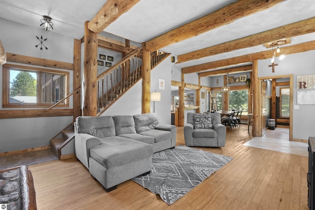 512 Indiana St, Manton, MI 49663 - living room with stairs, hardwood / wood-style floors, beam ceiling, and baseboards