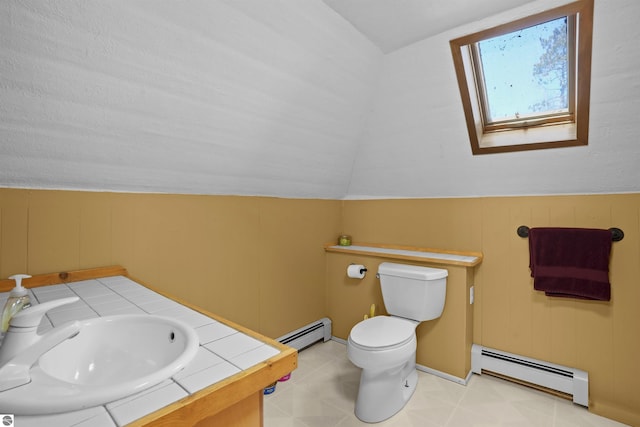 512 Indiana St, Manton, MI 49663 - half bath with baseboard heating, toilet, vaulted ceiling, a skylight, and vanity