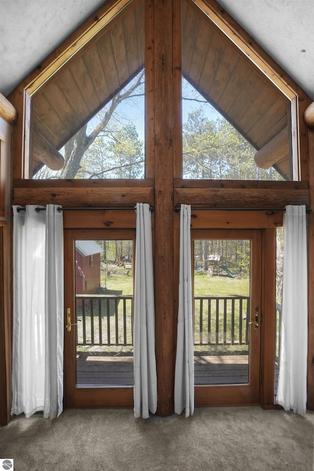 512 Indiana St, Manton, MI 49663 - doorway to outside with carpet, plenty of natural light, and high vaulted ceiling