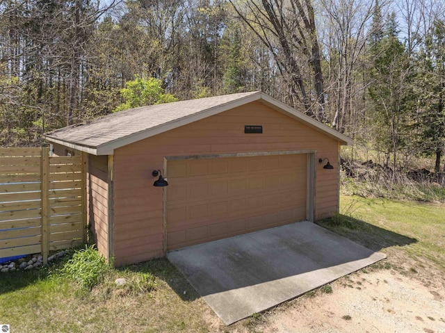 512 Indiana St, Manton, MI 49663 - detached garage featuring fence and a view of trees