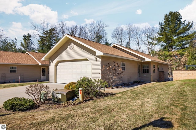 9803 Deer Track Ct, Interlochen, MI 49643 - view of side of home featuring a garage, driveway, a lawn, and roof with shingles