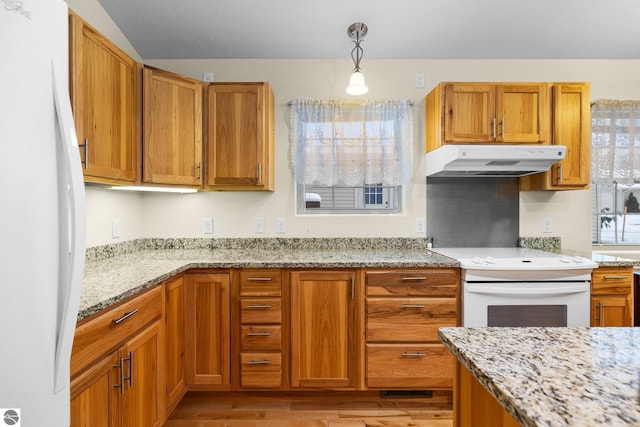 9803 Deer Track Ct, Interlochen, MI 49643 - kitchen with white appliances, under cabinet range hood, light wood-style floors, and brown cabinetry