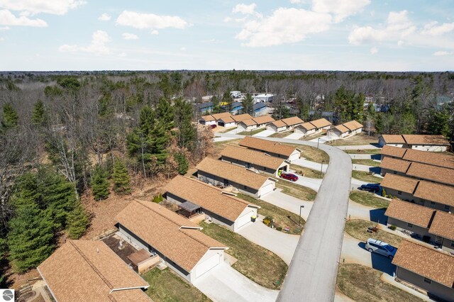 9803 Deer Track Ct, Interlochen, MI 49643 - aerial perspective of suburban area featuring a heavily wooded area