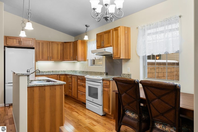 9803 Deer Track Ct, Interlochen, MI 49643 - kitchen featuring white appliances, under cabinet range hood, vaulted ceiling, a sink, and light wood-type flooring