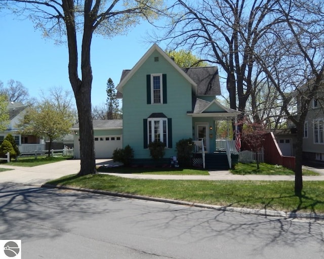 442 E Harris St, Cadillac, MI 49601 - view of front of house featuring an attached garage and driveway