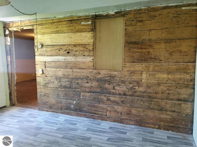 312 S Brown St, Edmore, MI 48829 - empty room featuring wooden walls and wood finished floors