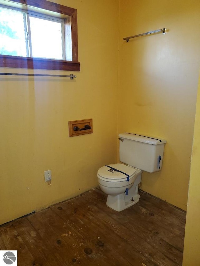 312 S Brown St, Edmore, MI 48829 - bathroom featuring hardwood / wood-style floors and toilet