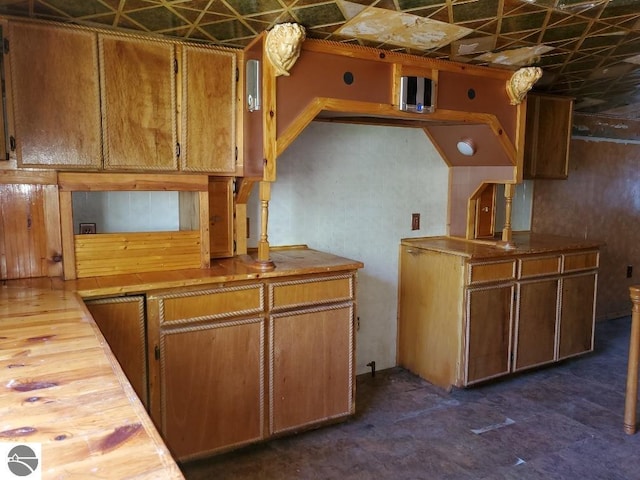 312 S Brown St, Edmore, MI 48829 - kitchen featuring an ornate ceiling, brown cabinetry, and butcher block countertops