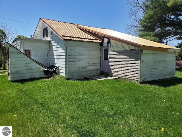 312 S Brown St, Edmore, MI 48829 - view of home's exterior featuring a lawn and metal roof
