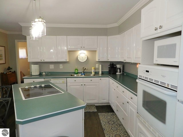 915 N Sunset Shores Dr, Lake Leelanau, MI 49653 - kitchen with white appliances, a sink, white cabinets, crown molding, and a center island
