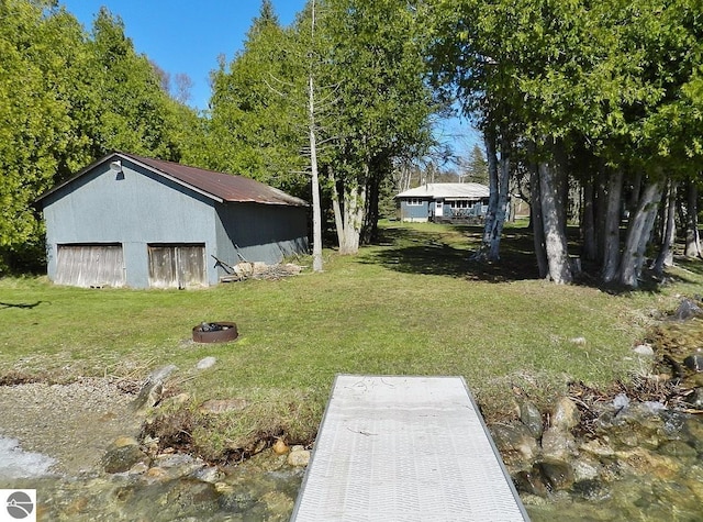 915 N Sunset Shores Dr, Lake Leelanau, MI 49653 - view of green lawn with an outbuilding, a pole building, and a detached garage