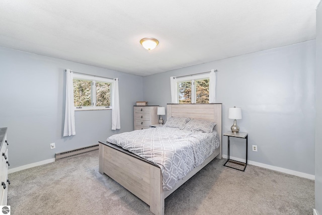 6450 W Lincoln Rd, Elwell, MI 48832 - carpeted bedroom with baseboard heating, multiple windows, and baseboards