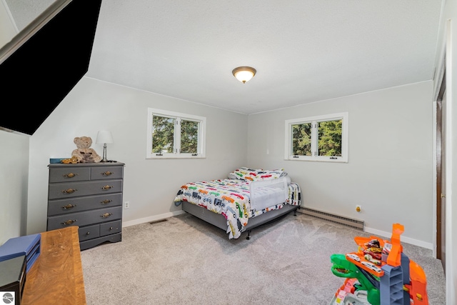 6450 W Lincoln Rd, Elwell, MI 48832 - carpeted bedroom with a baseboard radiator and baseboards