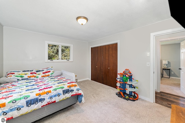 6450 W Lincoln Rd, Elwell, MI 48832 - bedroom featuring a closet, carpet flooring, and baseboards