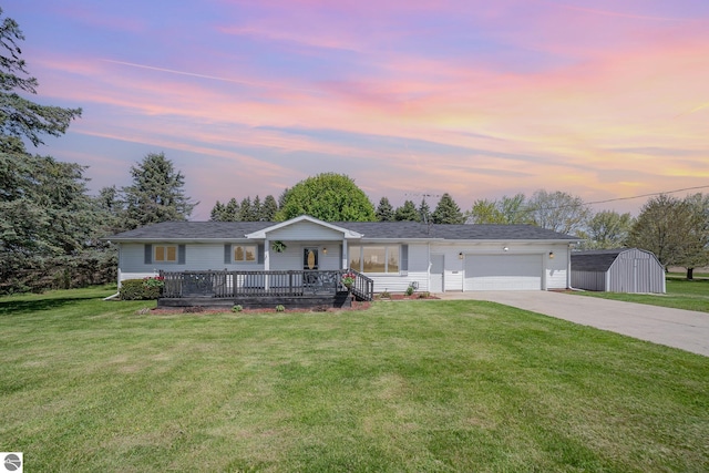6450 W Lincoln Rd, Elwell, MI 48832 - single story home with driveway, a garage, a lawn, and a porch